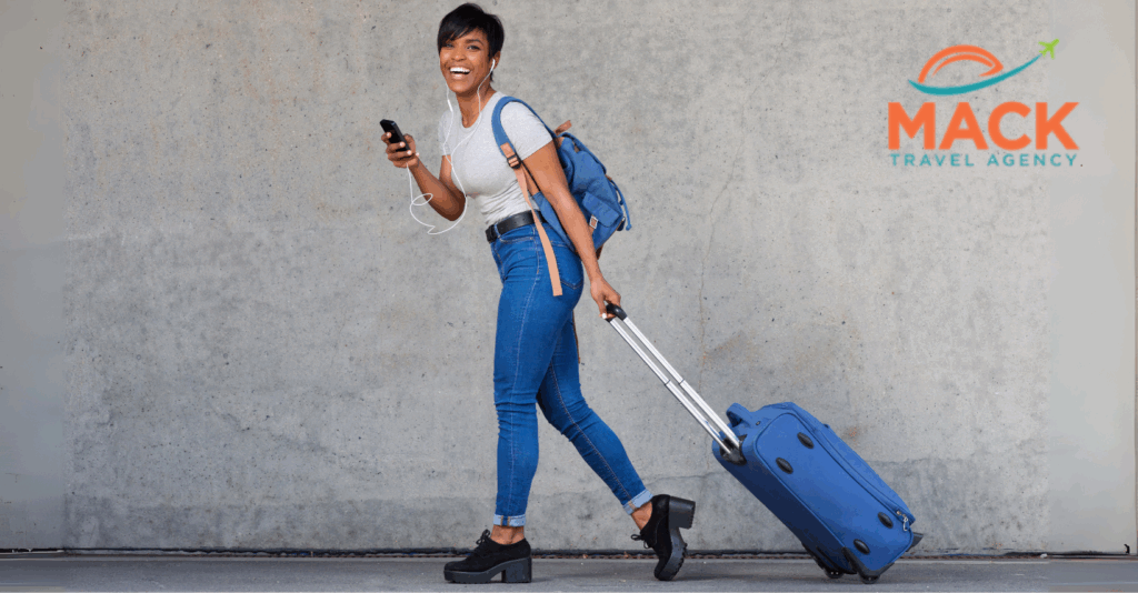 Happy Black woman traveling with suitcase, embodying freedom and excitement for a stress-free luxury travel experience.